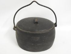 A large cast iron Siddons lidded cauldron, 17in high x 16.5in wide x 11.5in deep twinned with two fl