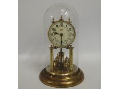 A Schatz glass domed anniversary clock, 12in high