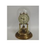 A Schatz glass domed anniversary clock, 12in high