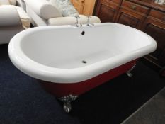 A red roll top bath with chrome feet & fittings, 7