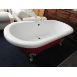 A red roll top bath with chrome feet & fittings, 7