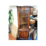 A glazed mahogany corner cabinet, 71in high x 23in