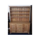 A large farmhouse pine dresser, 84in high x 60.5in