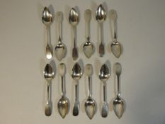 A set of twelve white metal tea spoons, monogramme