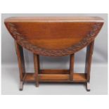 An oak gate leg table with carved decor to top, 36