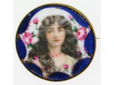 An enamel brooch depicting a young woman, 36mm dia