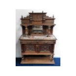 A carved oak ornate buffet with marble top & mirro