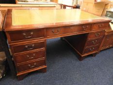 A mahogany pedestal desk with green top, 59.5in wi