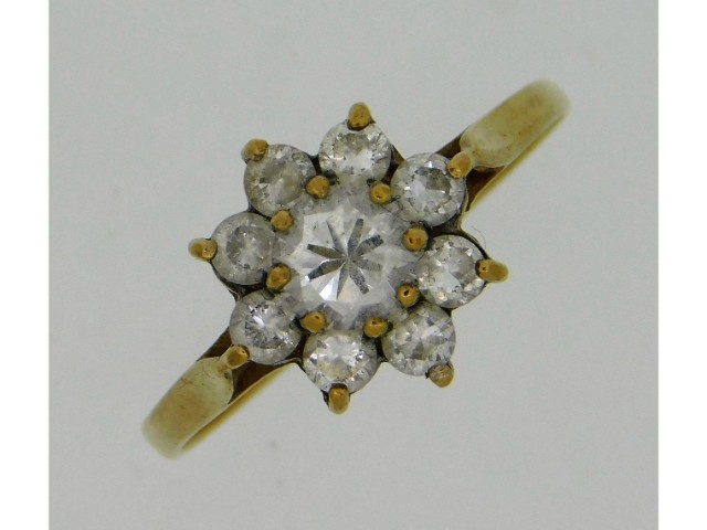 A 9ct gold ring set with paste stones, mark rubbed