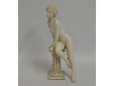 A 20thC. resin statue of girl leaning on a pedesta