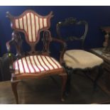 A decorative antique armchair, seat a/f twinned with a Victorian dining chair