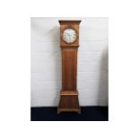 An antique pitch pine long case clock, running ord