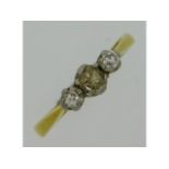 A 18ct gold three stone platinum set diamond ring,