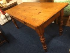 A pine farmhouse table with two drawers, 65in wide