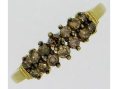 A 9t gold ring set with twelve small diamonds, 1.5