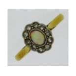 An antique 18ct gold ring set with opal & diamond,