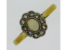 An antique 18ct gold ring set with opal & diamond,