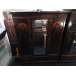 A large mahogany wardrobe with mirrored doors, 83i