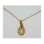 A 14ct gold pendant set with opal, 15mm drop, on a