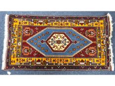 A woollen carpet, 65in wide x 33in deep