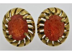 A pair of 9ct gold earrings set with orange stones