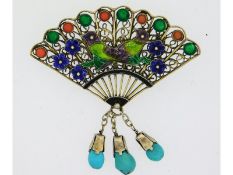 A sterling silver enamelled brooch decorated with