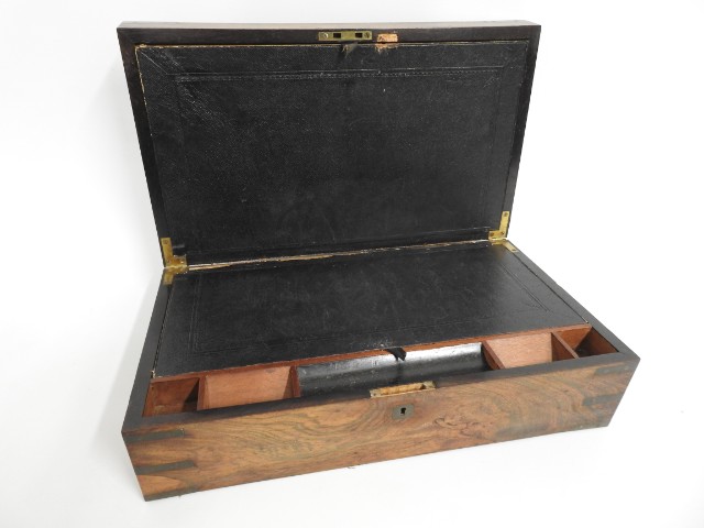 A walnut writing slope with brass fittings, 19.75i