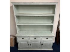 A large painted dresser with three drawers & three