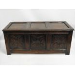 An oak coffer with carved panel design, 51in wide