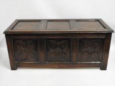 An oak coffer with carved panel design, 51in wide