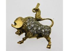 A yellow metal Taurus bull set with white stones,