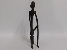 A bronze African figure, seated, 13.75in tall