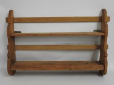 A stained pine shelf unit, 34in wide x 21in high