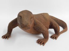 A carved wooden Komodo dragon lizard, 17in long