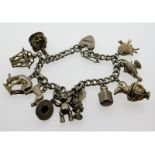 A silver charm bracelet, some charms unmarked, 63.