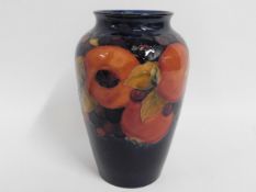 A Moorcroft pottery pomegranate vase, chip to inte