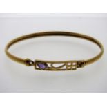 A 9ct gold bangle set with amethyst, 64mm diameter