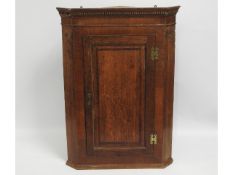 A 19thC. oak corner cupboard, 41in high x 29.25in