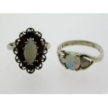 Two silver rings, one with opal & garnet, the othe