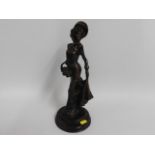 A 20thC. bronze figure of a woman, 13.75in tall
