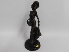 A 20thC. bronze figure of a woman, 13.75in tall