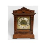 An oak cased mantle clock with brass dial, 11.25in