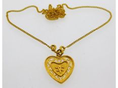 An Oriental 24ct gold chain & heart shaped 19mm di