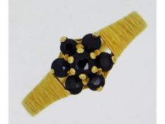 An 18ct gold bark effect ring set with sapphire, 2