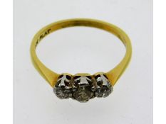 A 18ct gold three stone platinum set diamond ring,