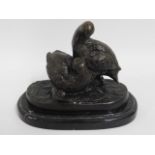 A pair of bronze birds on marble plinth after Chri