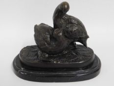 A pair of bronze birds on marble plinth after Chri