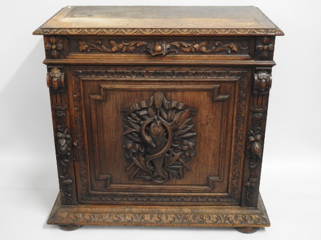 A 19thC. oak chest with unusual carved fish & serp