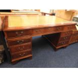 A mahogany pedestal desk with green top, 59.5in wi