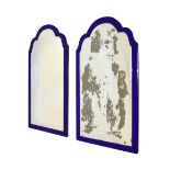 Near pair of wall mirrors with blue mirrored glass borders